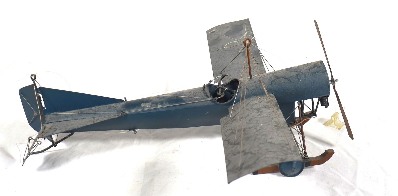 Vintage folk art or model replica of an early 20th-century monoplane: Vintage folk art or model replica of an early 20th-century monoplane, possibly a Blériot XI or a similar design like the 1911 Blackburn Second Monoplane. The model appears to be made