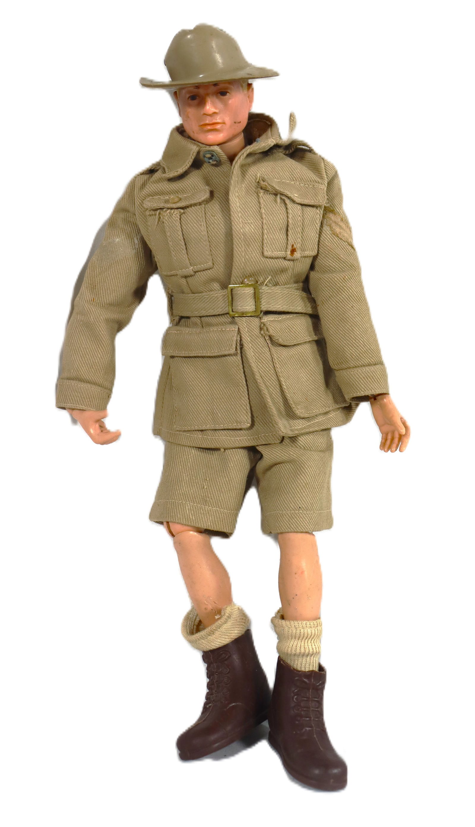 Vintage 1960s GI Joe 12-inch action figure: Vintage 1960s GI Joe 12-inch action figure The uniform is a tan/khaki color, consisting of a belted jacket with four pockets and matching shorts. It includes dark brown boots and