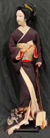 Vintage Japanese Geisha doll with a black or dark purple kimono and a shamisen