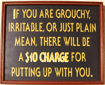 Framed humorous, decorative sign with a warning about charging people for bad behavior.