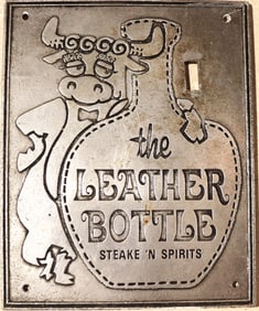 vintage metal light switch plate or wall plaque advertising "The Leather Bottle Steaks 'N Spirits",