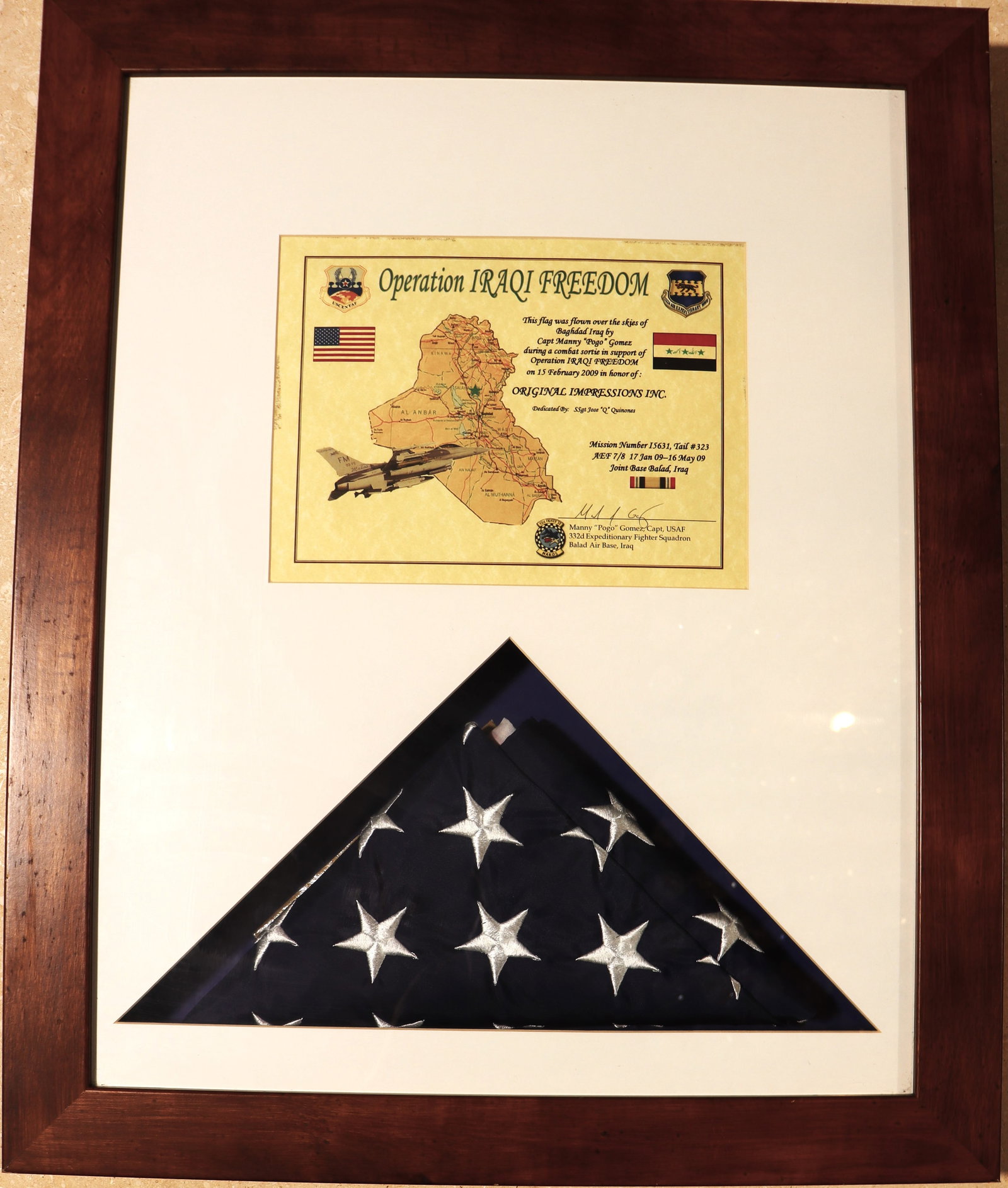 Framed display is a commemorative item related to military service during Operation Iraqi Freedom.: Framed display is a commemorative item related to military service during Operation Iraqi Freedom. It honors "Original Impressions Inc" and lists a mission number and dates o