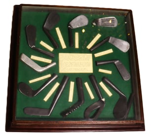 Vintage decorative shadow box displaying the history of golf club head