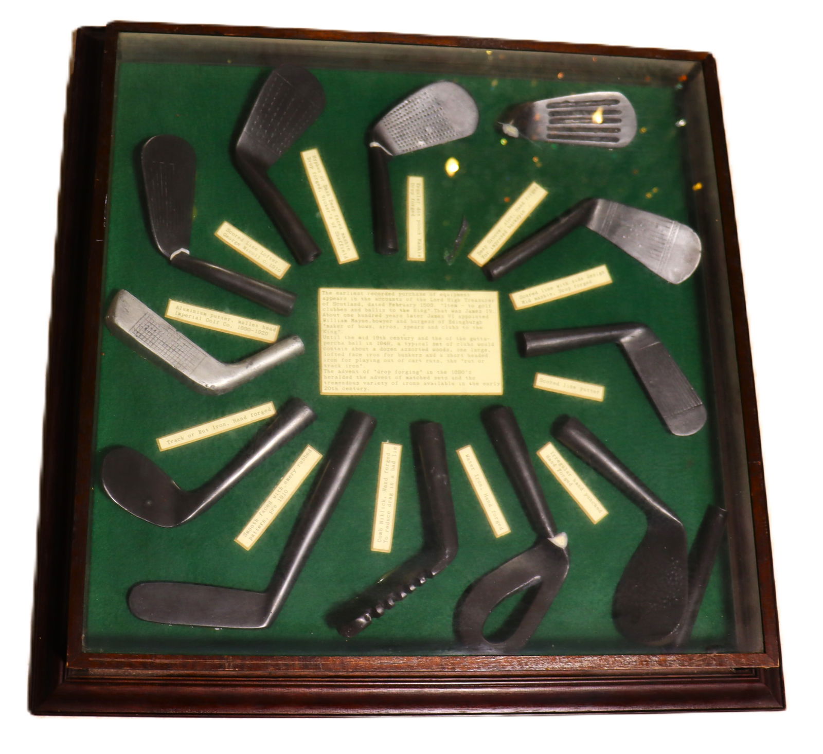 Vintage decorative shadow box displaying the history of golf club head: Vintage decorative shadow box displaying the history of golf club head (two of them are broke) The image shows a framed display, often referred to as a shadow box, containing a collection of miniature