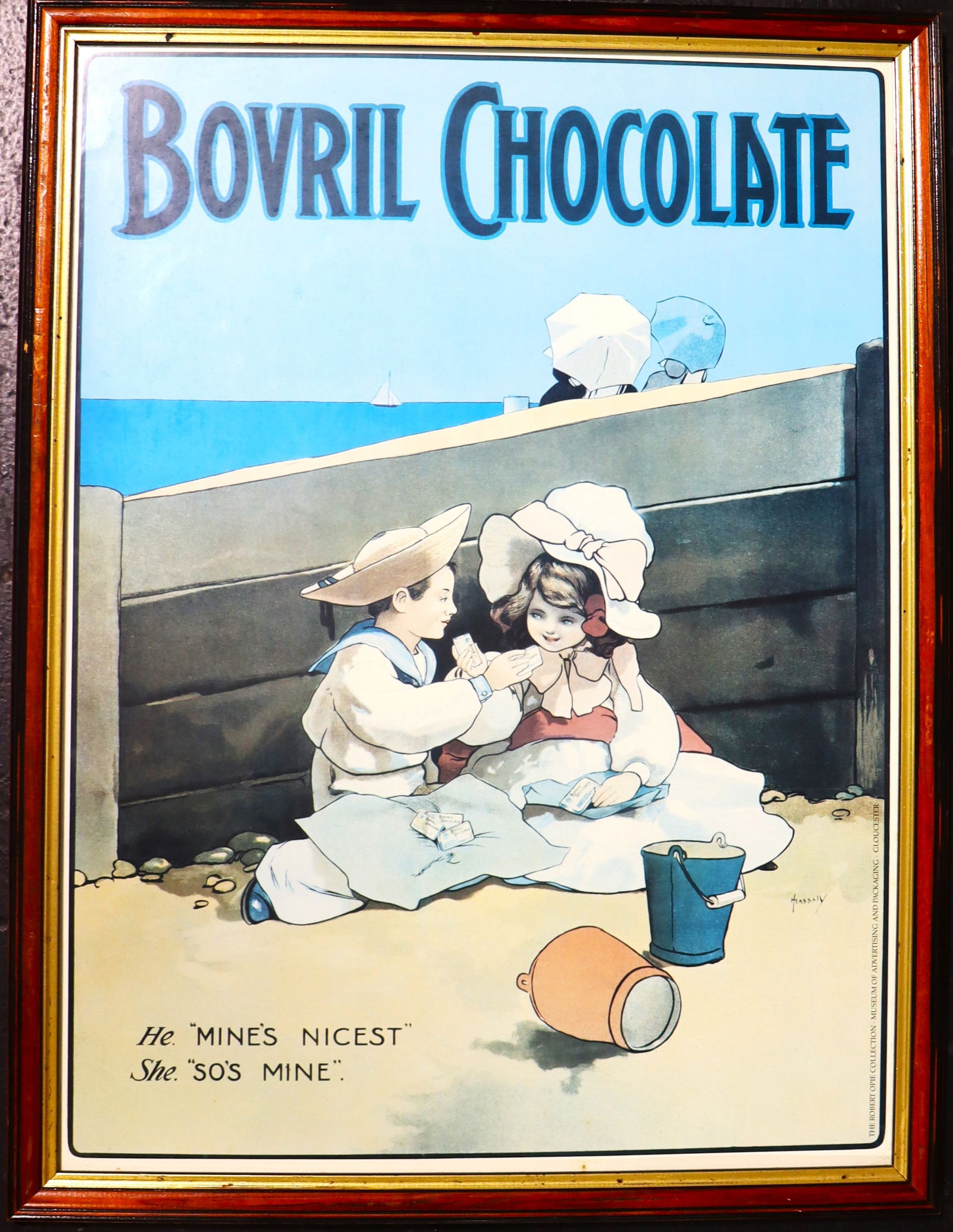Framed Vintage Advertising of Bovril Chocolate: Framed Vintage Advertising of Bovril ChocolateThis is a reproduction of a vintage Bovril Chocolate advertising poster from the 1900s. The artwork is attributed to the artist John Hassal. The poster