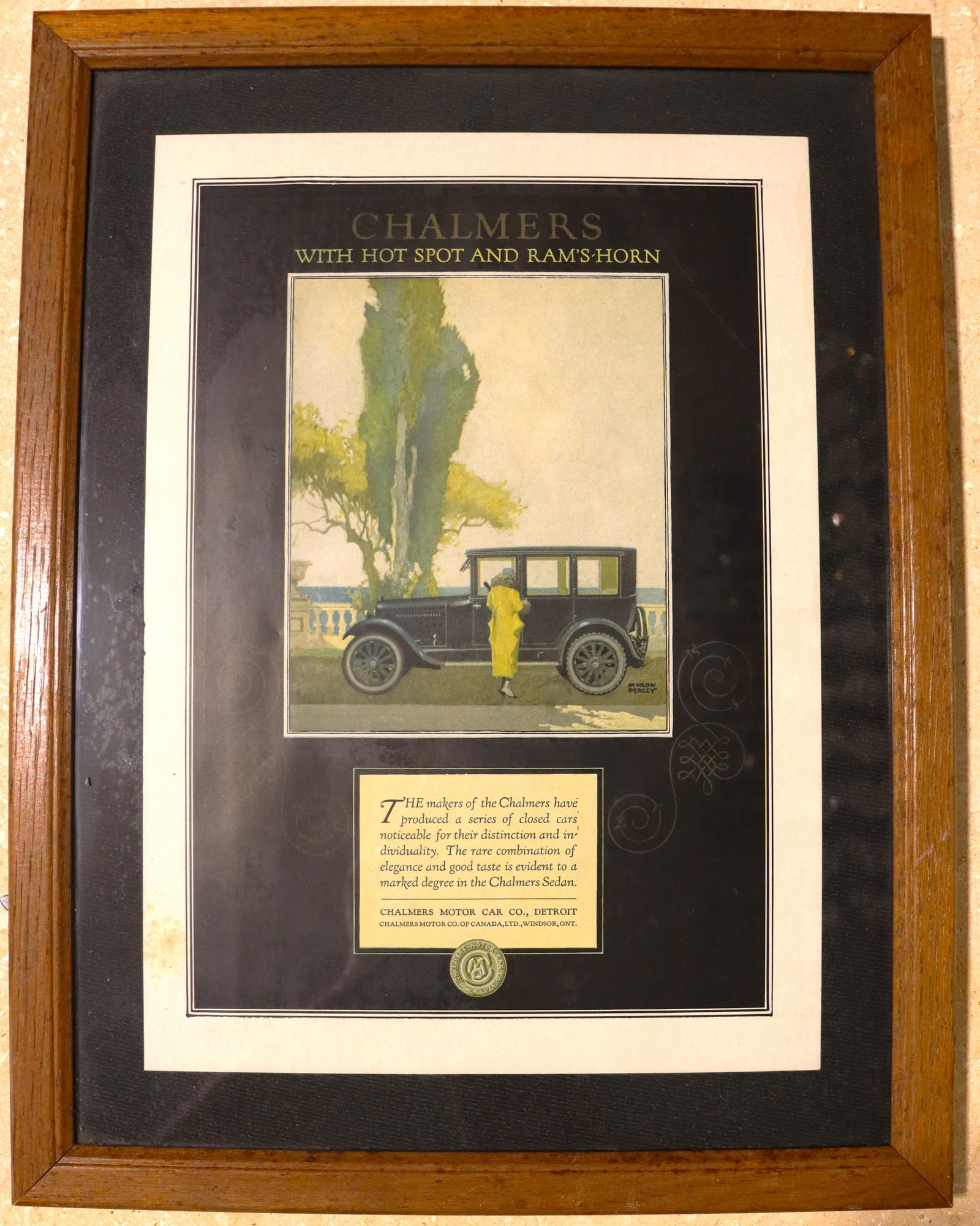 Framed Vintage Advertising for the Chalmers Motor Car Company.: Framed Vintage Advertising for the Chalmers Motor Car Company.The image shows a vintage advertisement for the Chalmers Motor Car Company. The ad features a Chalmers Sedan and highlights the