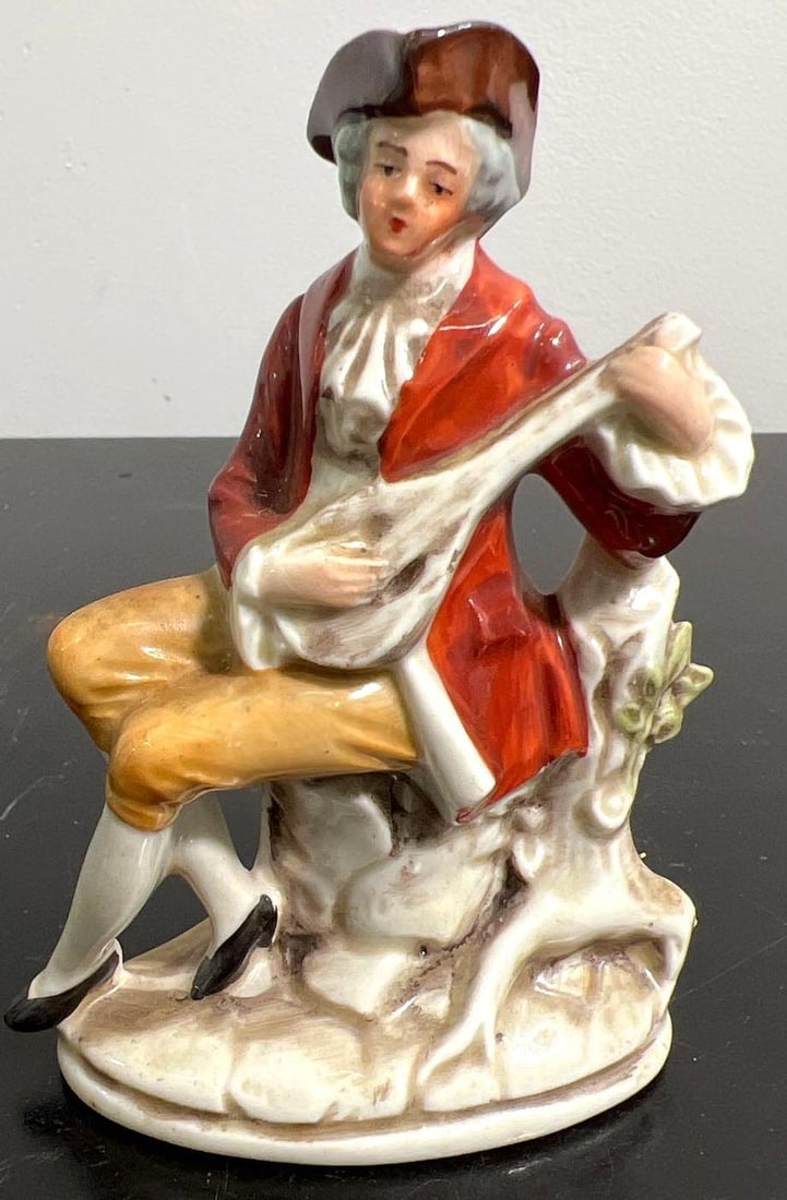 Porcelain figurine Man playing instrument. (1 of 7)