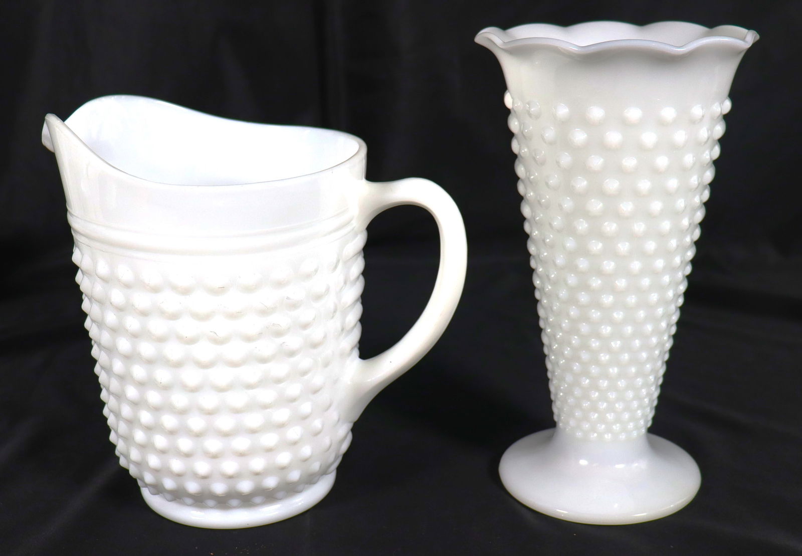 Vintage white hobnail milk glass pitcher,and one white milk glass vase featuring the hobnail: Vintage white hobnail milk glass pitcher, and one white milk glass vase featuring the hobnail pattern, a ruffled edge, and a footed base. DIMENSIONS Pitcher Height: 8 inch / 20,2 cm 