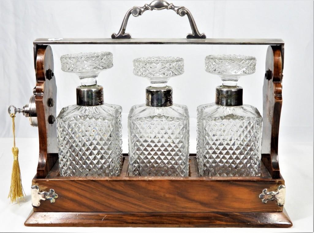 Betjemann's Patent Tantalus LONDON England: The Tantalus Betjemann's Patent 27340 London" stamped locking handle with the original three gorgeous and intact cut crystal decanters and their stoppers resting in a crotch mahogany case Inc