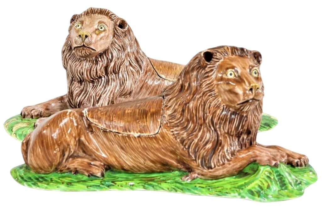 TWO LIONS IN SOFT CHANTILLY PORCELAIN OF THE EIGHTEENTH CENTURY, AND TWO FAIENCE LIDS: TWO LIONS IN SOFT PORCELAIN OF CHANTILLY OF THE XVIII Century, AND TWO LIDS IN FAIENCECIRCA 1740, MARKS IN BROWN WITH HUNTINGHORN Represented lying on a curved oval base, the first looking on the