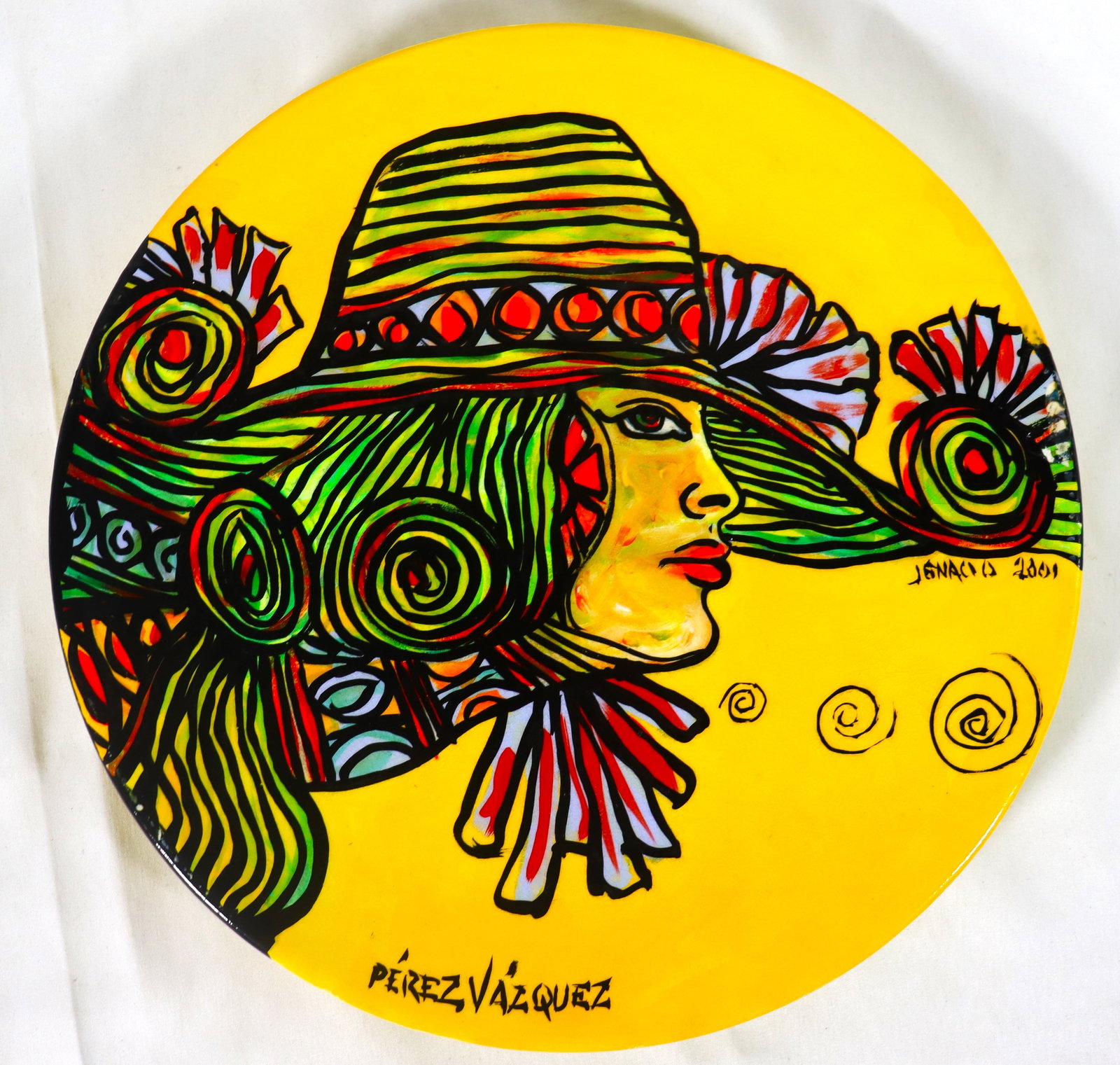 CERAMIC Plate signed Jignacio tiltled PEREZ Vazquez afroguajiras cuba nostagia dated 2001: CERAMIC Plate signed Jignacio, tiltled PEREZ Vazquez afroguajiras cuba nostagia dated 2001 DIMENSIONS: Diameter: 9.80 inch / 25 cm 