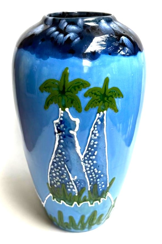Vintage pottery vase featuring a palm tree design. signed Navarrete: Vintage pottery vase featuring a palm tree design. signed Navarrete Juan A. Navarrete (1952- Cuba) We do not have a COA for this piece and is therefore being sold in the manner of Juan A.