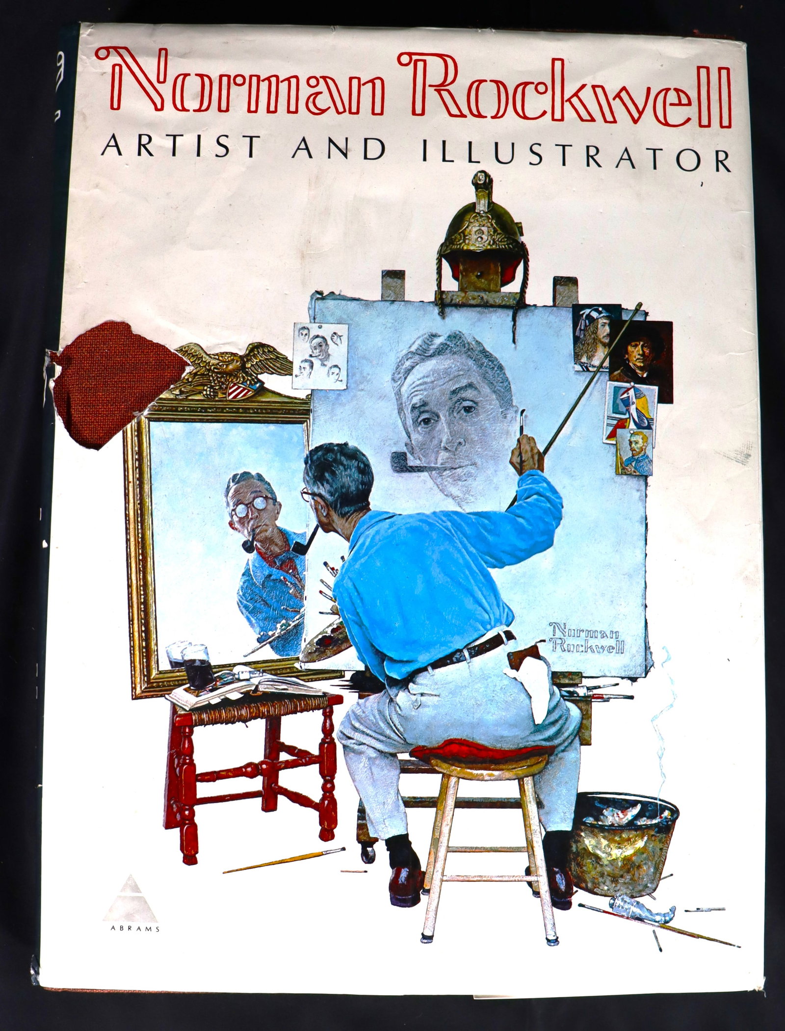 Vintage hardcover art book titled "Norman Rockwell: Vintage hardcover art book titled "Norman Rockwell, Artist and Illustrator" by Thomas S. Buechner, featuring iconic illustrations of American popular culture. Showcases over 600 il