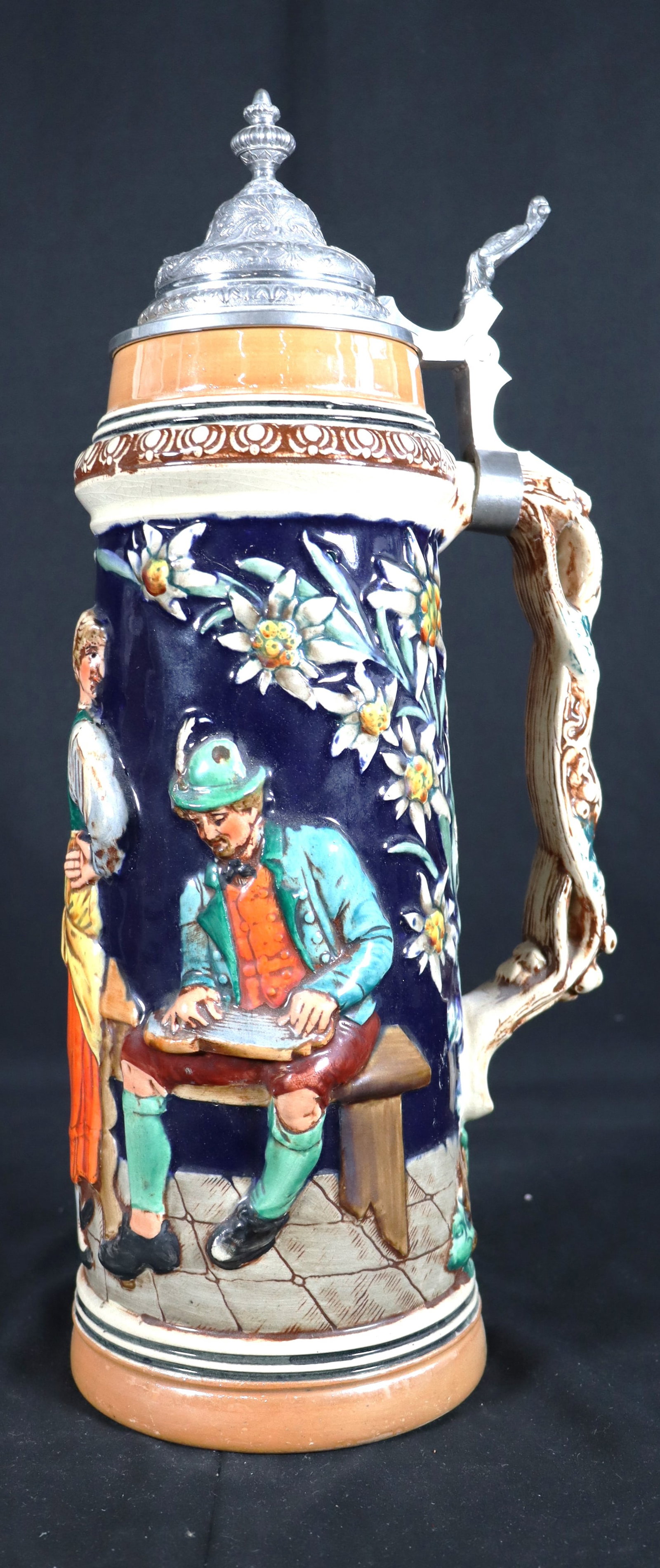 Vintage classic German beer stein, likely crafted from ceramic with a relief decoration and a pewter (1 of 7)