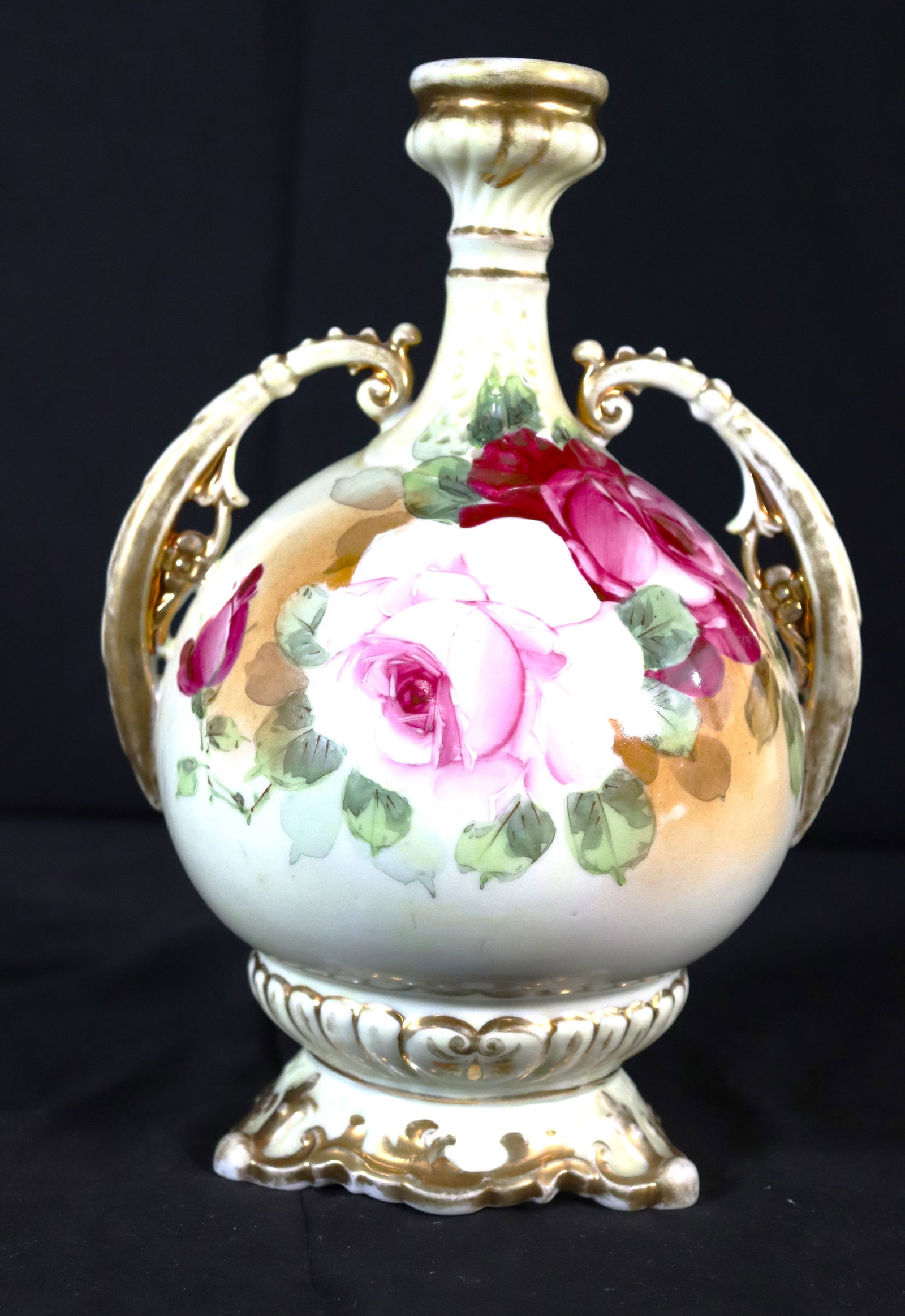 A fine unmarked two handle vase having hand painted rose decoration and fine gilt highlights. (1 of 8)