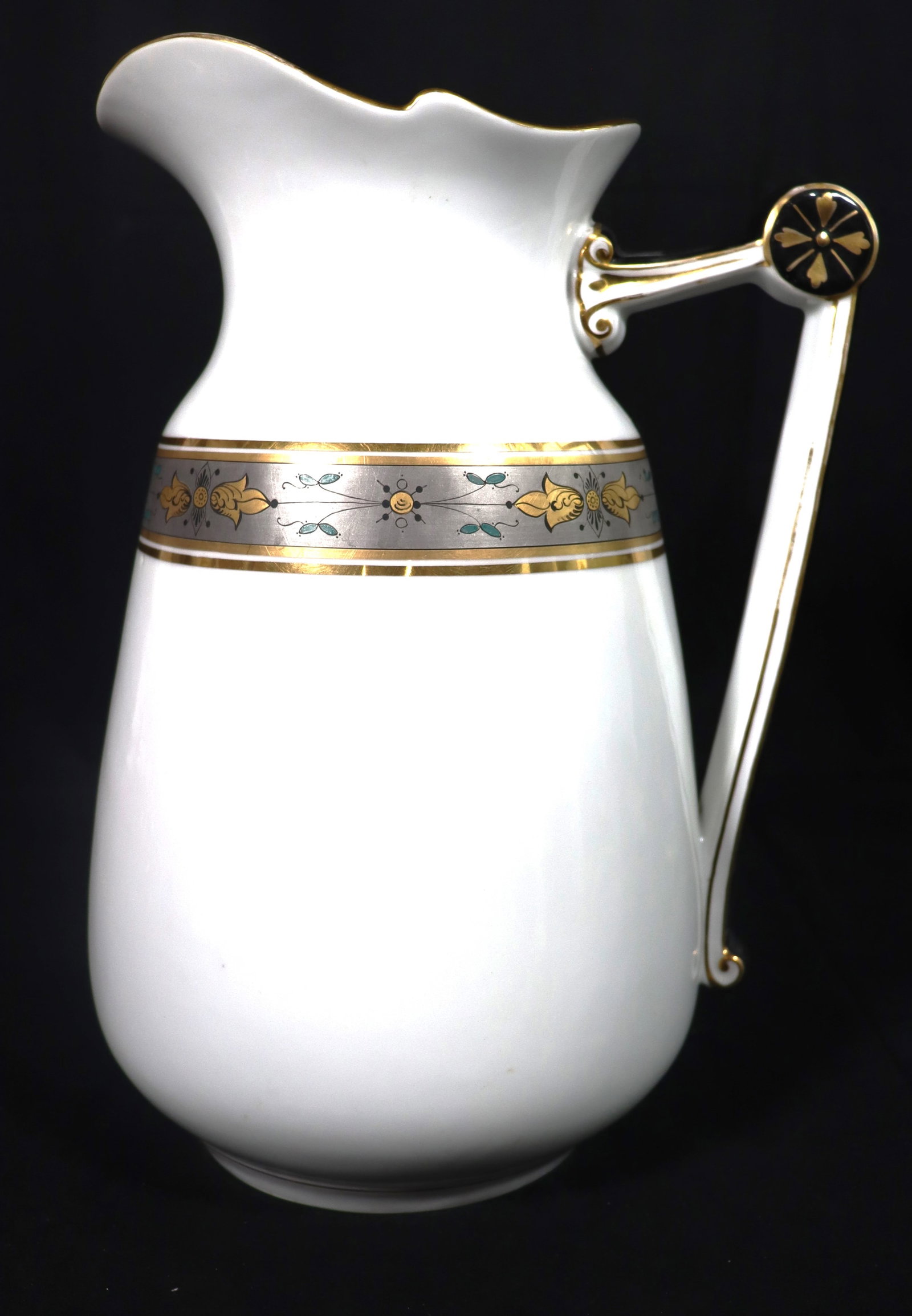 Pitcher, Porcelain, Gold Band - - molded white porcelain, and gold decoration on handle and spout,: Pitcher, Porcelain, Gold Band - - molded white porcelain, and gold decoration on handle and spout, and an incised "D T" on bottom. DIMENSIONS: Height: 12.50 inch / 31,7 cm 