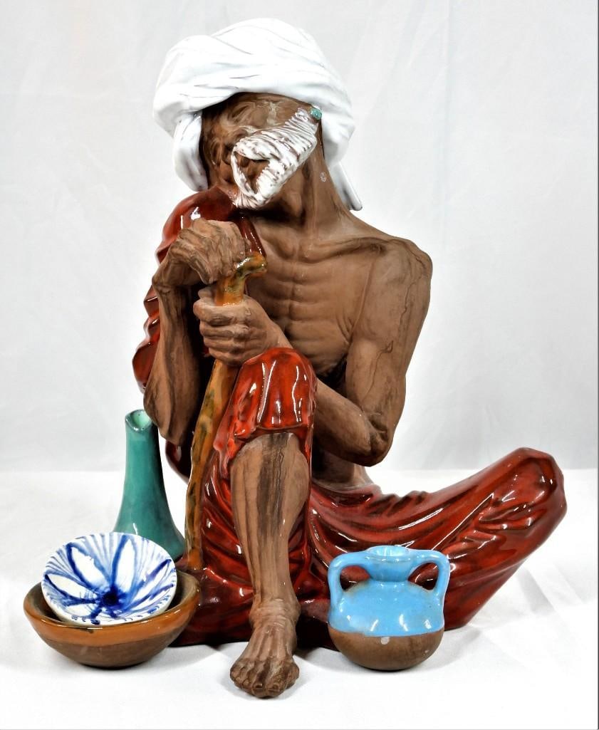 Large Algora porcelain seated old man figurine.: Algora porcelain seated old man figurine. DIMENSIONS: Height 11.50 inch / 29 cm Length 10 inch / 26 cm 
