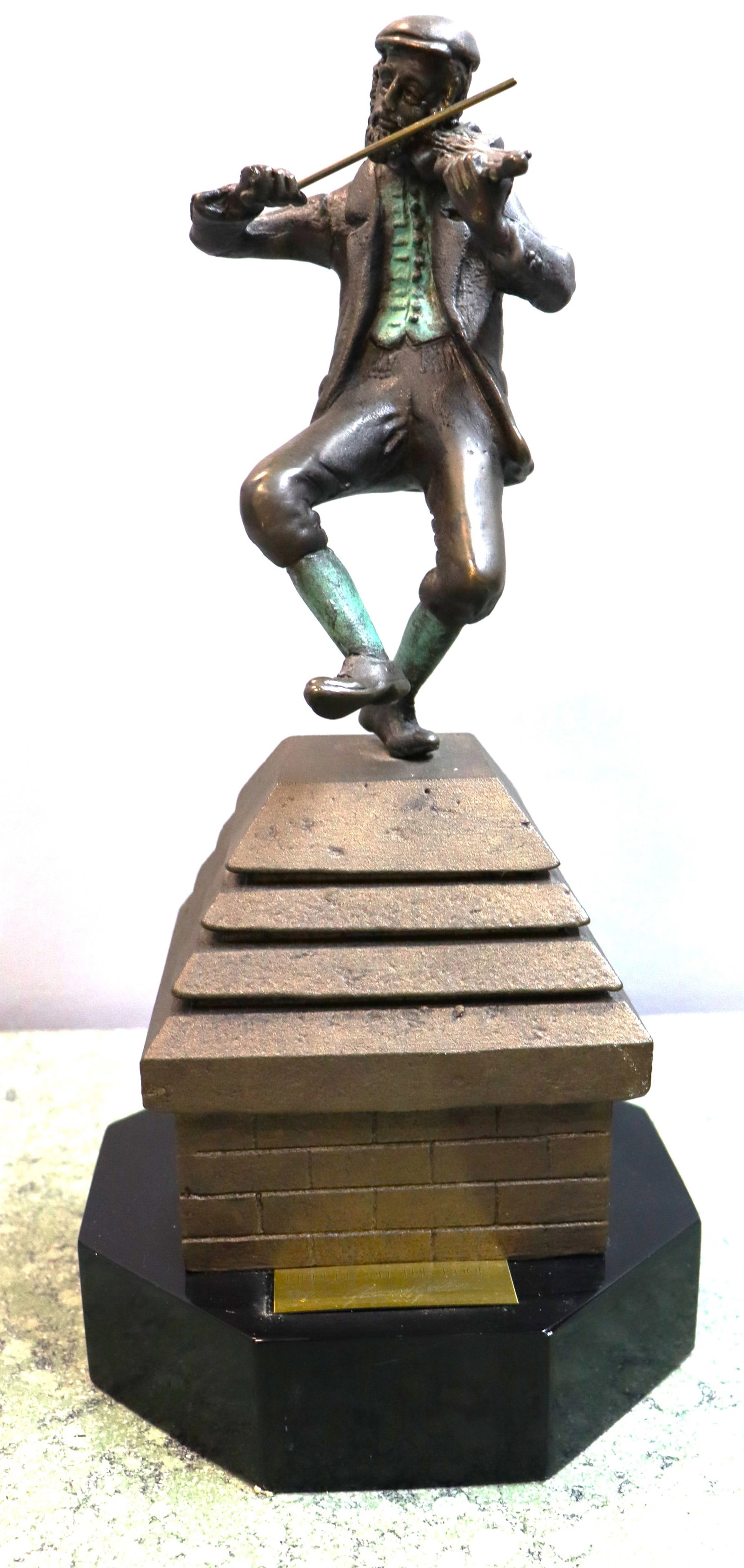 Bronze sculpture by artist Yaacov Heller, featuring a verdigris patina on the vest and socks.: Bronze sculpture by artist Yaacov Heller, featuring a verdigris patina on the vest and socks. Titled "Fiddler on the Roof" with the figurine mounted on a tiered metal base.DIMENSIONS: Height: inch /