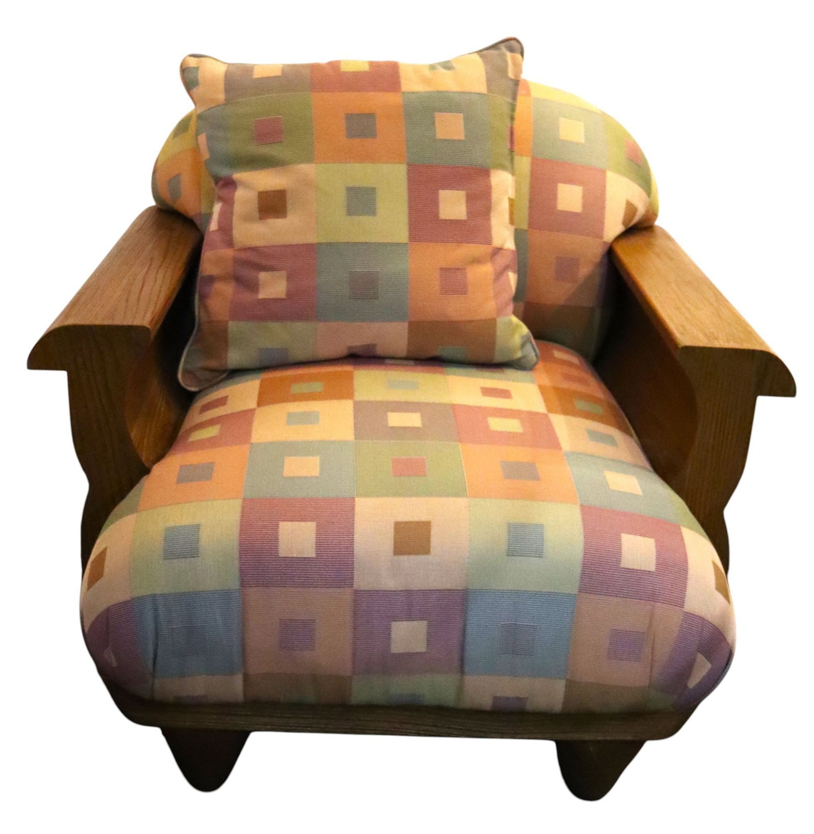 Vintage Oak Armchair with Colorful Geometric Upho: This vintage armchair features a robust oak frame with broad, rounded armrests and a distinctive silhouette. The chair is upholstered in a vibrant fabric with a geometric square pattern in a pastel