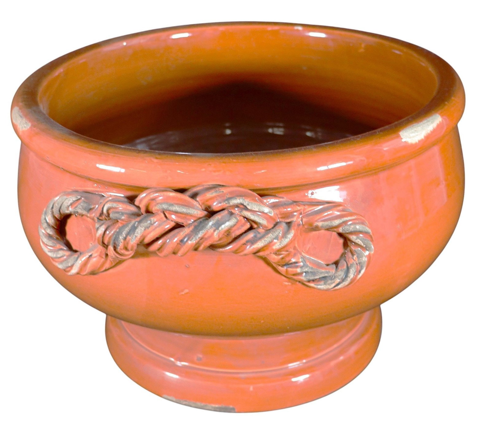 Vietri Terracotta Rope Knot Bowl Planter Made in: This is a charming terracotta bowl, likely functioning as a planter, handcrafted by Vietri in Italy. The bowl features a vibrant orange-brown glaze, giving it a rustic yet refined aesthetic. A distinc