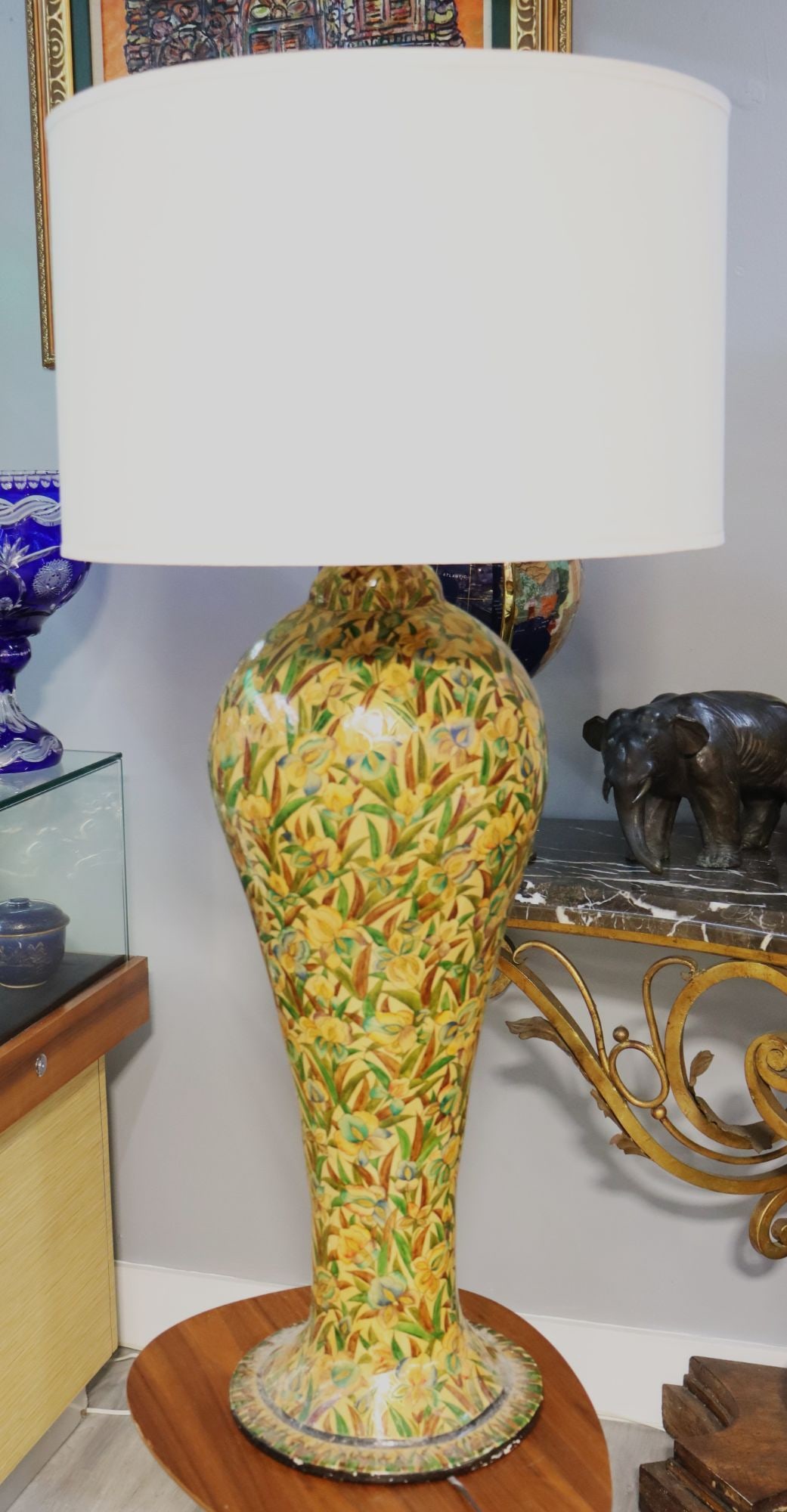 Vintage Hand-Painted Floral Table Lamp with White: This exquisite vintage table lamp features a hand-painted floral design on its elegant, curvaceous base. The intricate pattern showcases a vibrant array of irises and foliage in shades of yellow, blue