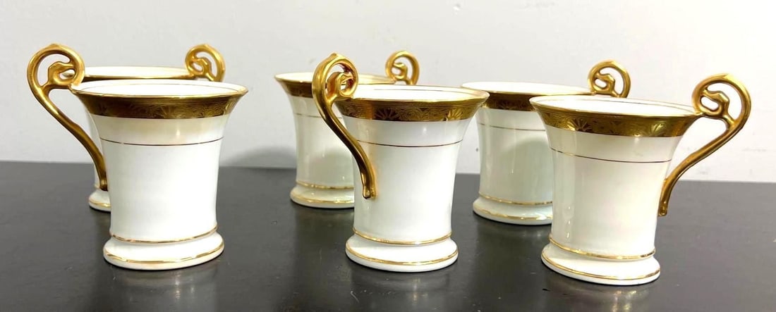 Set of 6 Tiffany & Co. for Mintons Gilt Porcelain: This exquisite set features six demitasse cups, crafted from fine porcelain and adorned with luxurious gilt decoration. Each cup bears the distinguished mark of Tiffany & Co. New York, indicating thei