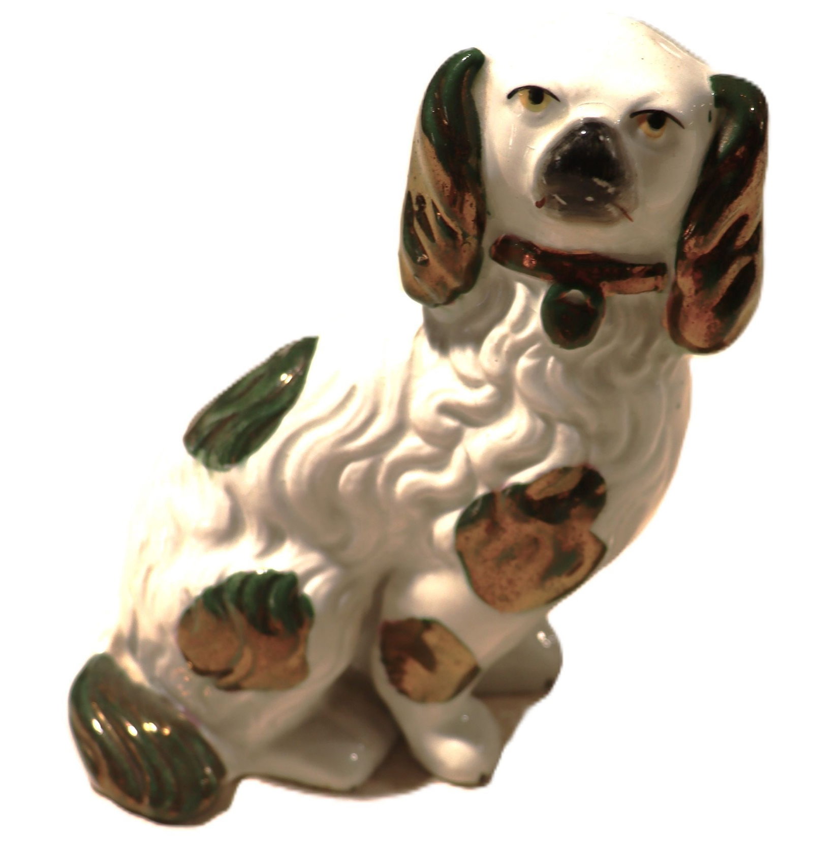 Staffordshire Spaniel Dog Figurine, White with Gr: This charming vintage ceramic figurine depicts a spaniel dog, rendered in a seated position with a watchful expression. The dog features a white glaze base with hand-painted green and gold accents on 
