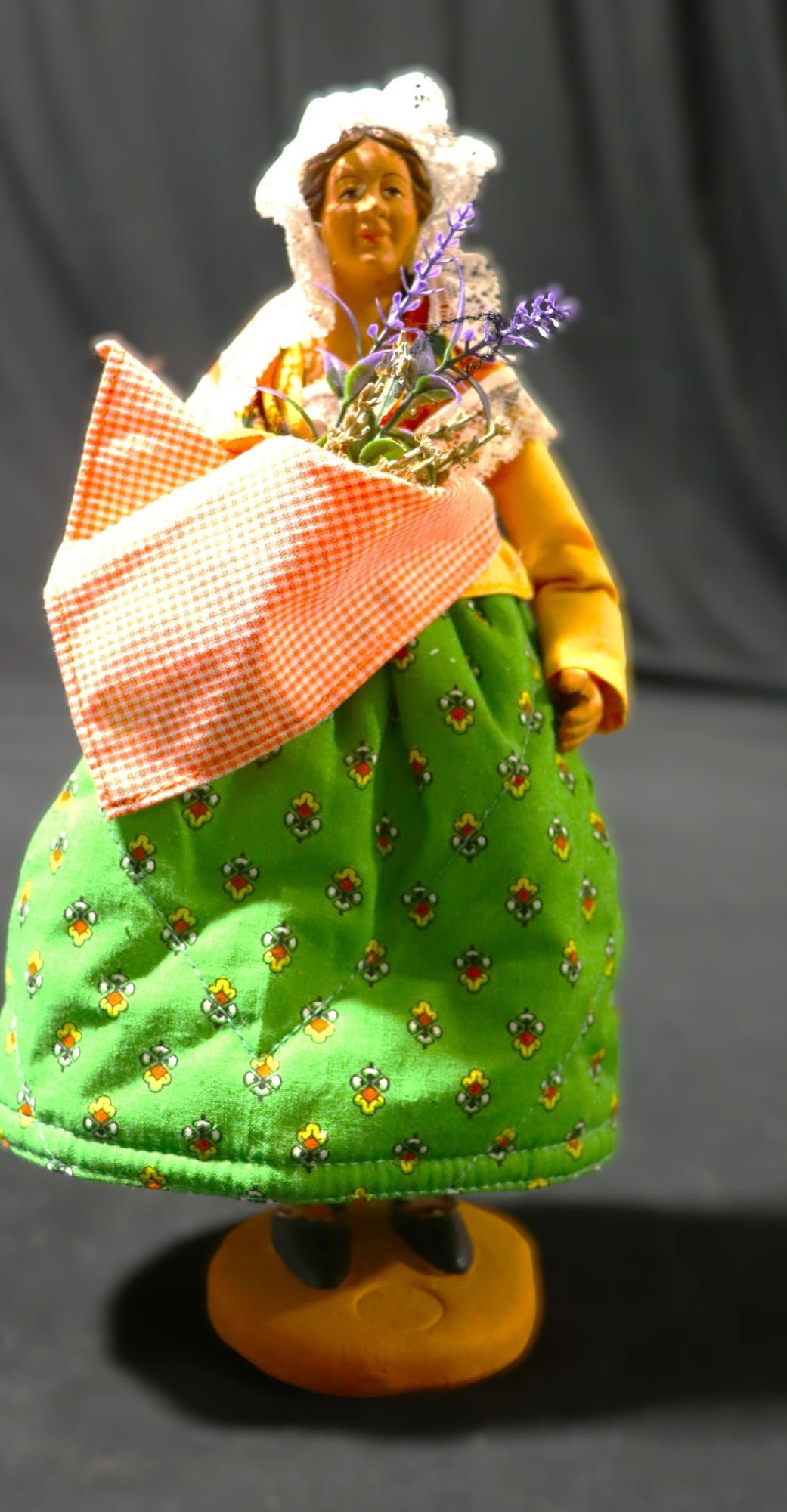 Vintage French Santon Figurine Woman with Lavende: This is a charming vintage French Santon figurine, depicting a woman in traditional Provençal attire. The figure features a terracotta head and hands, with a fabric-dressed body. She wears a white la