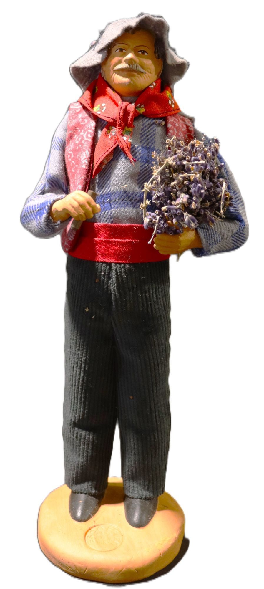 Vintage French Provençal Santon Figure Man with L: This charming vintage santon figure depicts a man in traditional Provençal attire, holding a bouquet of dried lavender. The figure is crafted from terracotta with a hand-painted face and hands, compl