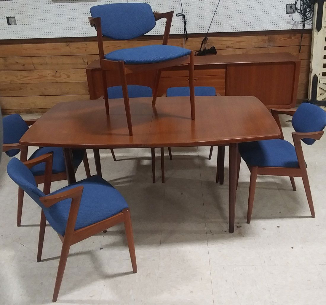 Mid Century Dining Room Table with 6 chairs and 2 leave: Mid-century dining room table including six chairs and two leaves. Made in Denmark.Mid-century dining room table including six chairs and two leaves. Made in Denmark. 63 in by 38 in by 29 in high. Eac