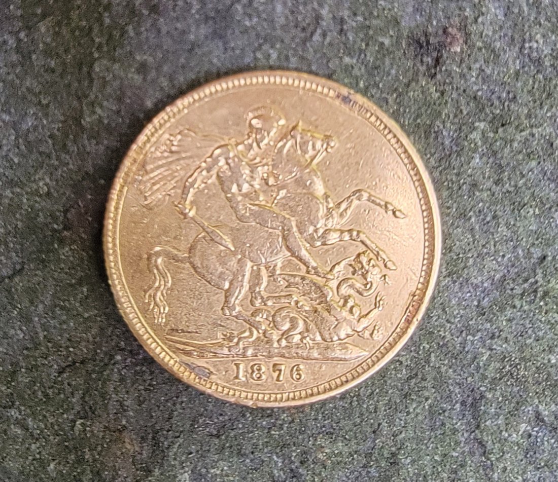 1876 Queen Victoria Gold Sovereign Coin: This is a scarce coin. This is a Queen Victoria Gold Sovereign from 1876 with the Young Head design by William Wyon. The reverse features the traditional George and Dragon design provided in a plastic