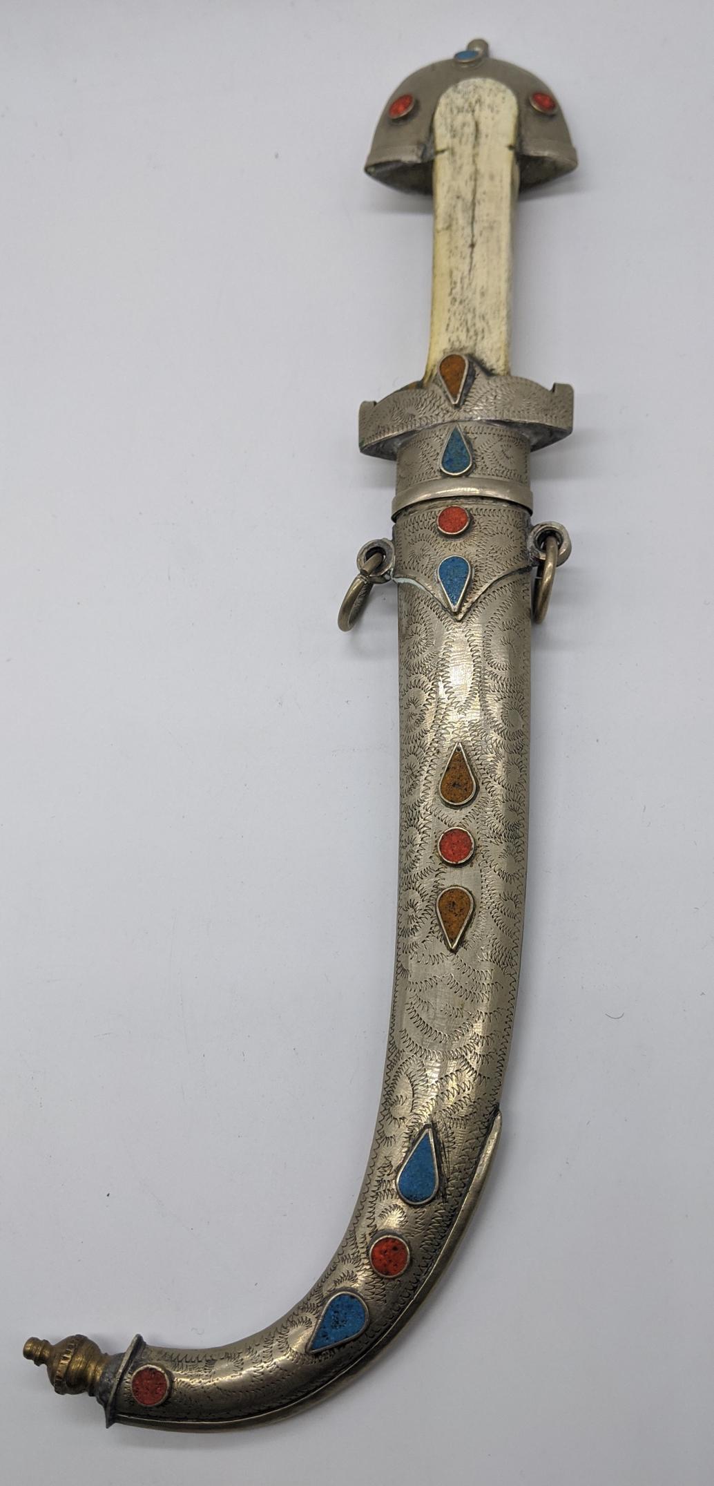 A Middle Eastern Khanjar dagger, mounted with red and: A Middle Eastern Khanjar dagger, mounted with red and blue stones with a bone handle, L.33cm