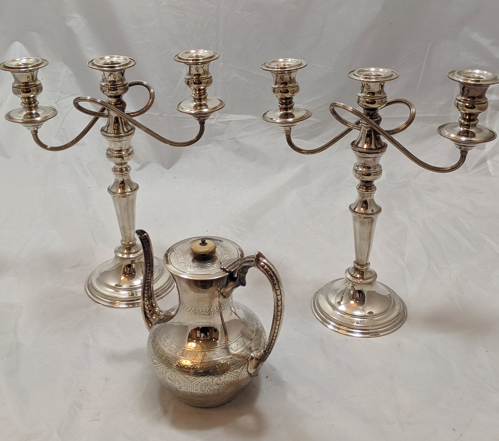 A pair of silver plated three light candelabras H.36cm,: A pair of silver plated three light candelabras H.36cm, together with a late 19th century silver plated jug