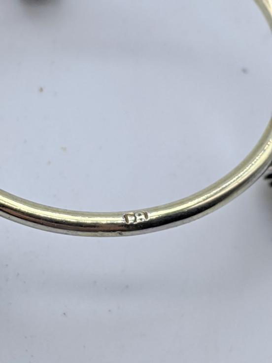 A Russian 19th century silver Easter egg holder, raised: A Russian 19th century silver Easter egg holder, raised on three legs in the form of dolphins, H.2.5cm D.5.5cm