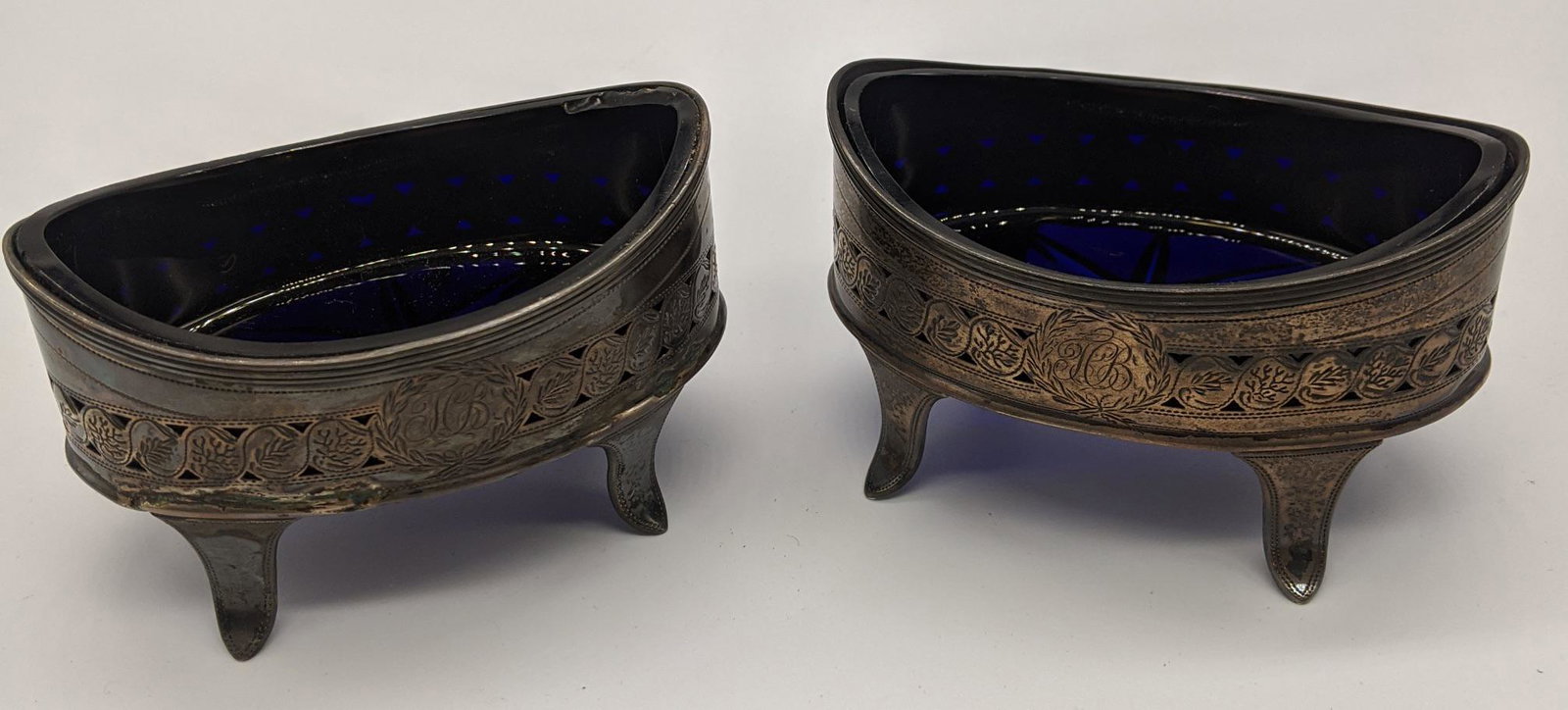 A pair of George III silver salts with blue glass: A pair of George III silver salts with blue glass liners, hallmarked London, 1797, maker Henry Chawner and John Eames, initialled, 250g (including glass liners) H.5.5cm L.8.5cm