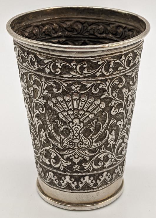 An early 20th century Indonesian silver beaker, chased: An early 20th century Indonesian silver beaker, chased with scrolling floral and fauna designs, initialled, 70.5g, H.8cm