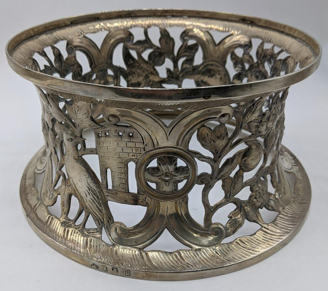 An Edwardian Irish silver potato ring by Elkington &: An Edwardian Irish silver potato ring by Elkington & Co., decorated with scrolling flora and fauna, vacant cartouche, hallmarked Dublin, 1907, maker Elkington & Co., 385g, H.10.5cm D.18.5cm