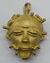 An 18ct gold African mask pendant/brooch, marks for