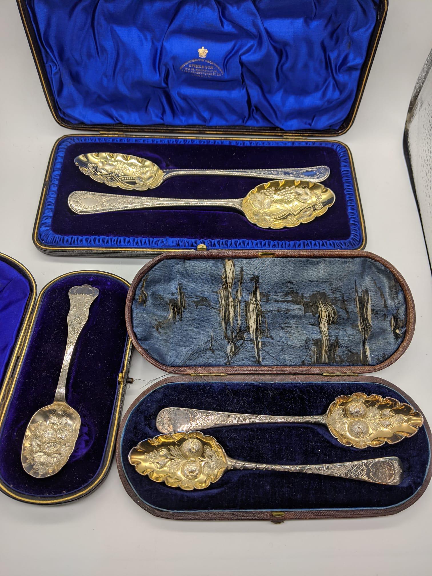A pair of George IV silver tablespoons with etched: A pair of George IV silver tablespoons with etched designs, cased, together with a cased pair of Victorian silver berry spoons and a cased Victorian silver berry spoon, 300g