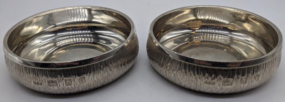 A pair of Gerald Benney silver coasters, bark effect: A pair of Gerald Benney silver coasters, bark effect finish, hallmarked London, 1971, 320g, H.3cm D.10cm