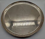 An early 20th century silver salver, raised on 3 feet, hallmarked London, 1925, engraved, 1128g,