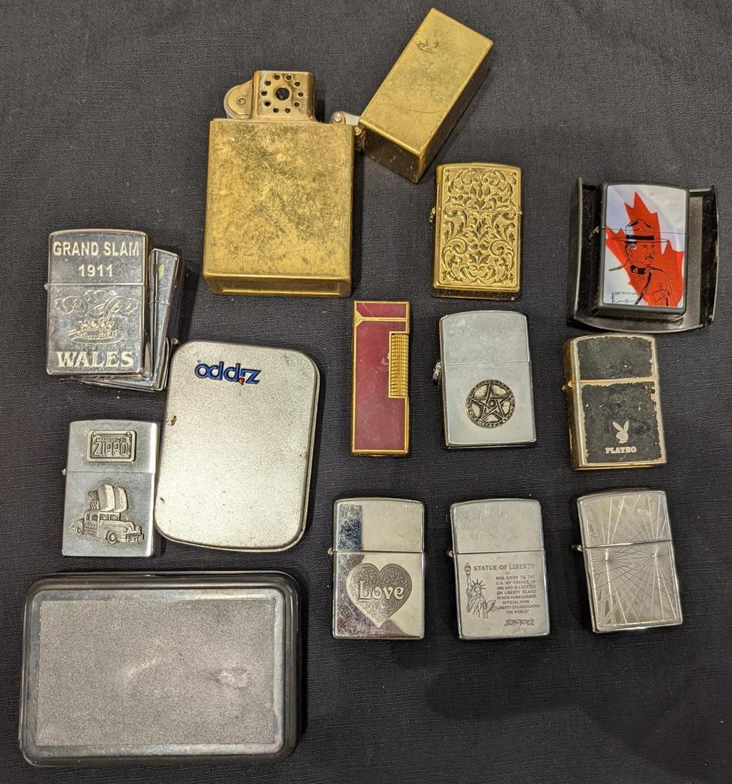 A Dunhill red lacquered lighter together with a collection of other lighters, mostly Zippo: A Dunhill red lacquered lighter together with a collection of other lighters, mostly Zippo