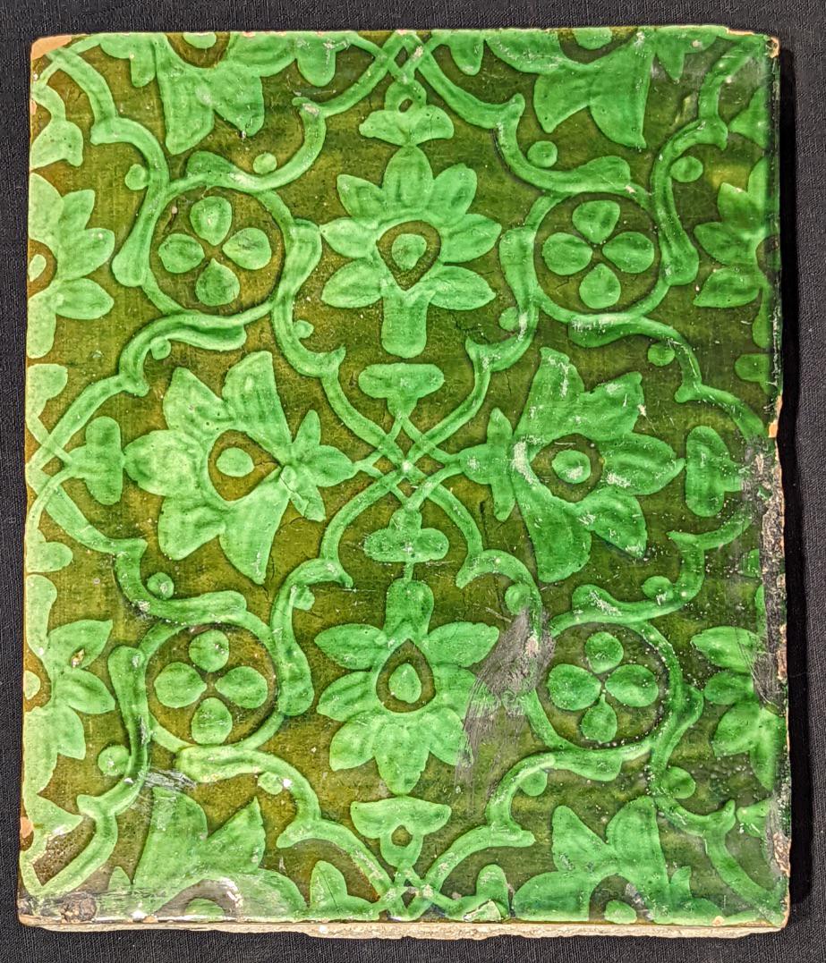 A 19th century Indian green glazed pottery tile, 26.5cm x 21.5cm: A 19th century Indian green glazed pottery tile, 26.5cm x 21.5cm