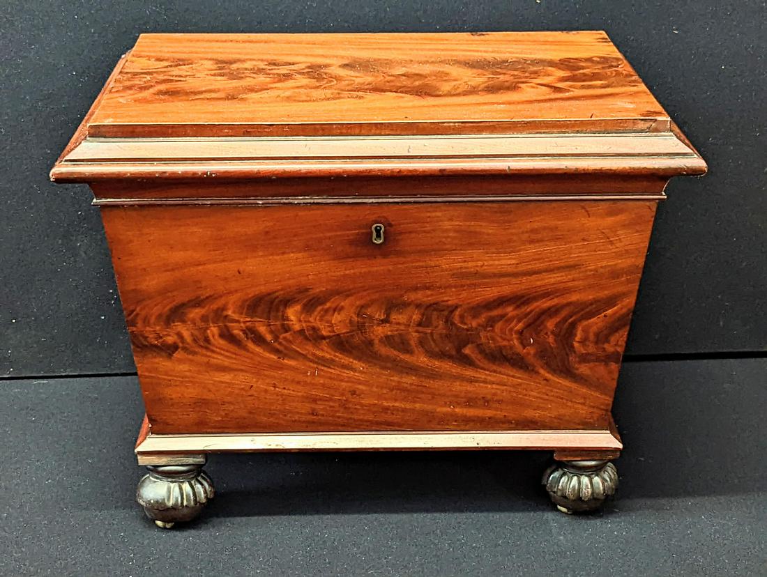 A mahogany wine cooler, raised on casters, L.64cm: A mahogany wine cooler, raised on casters, L.64cm