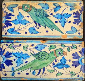 Two early/mid 19th century Mughal multan tiles depicting green parrots, each 15.5cm x 30cm