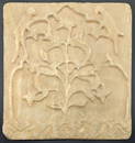 A rare 18th century Mughal Indian carved alabaster tile depicting a tree within a mihrab design with