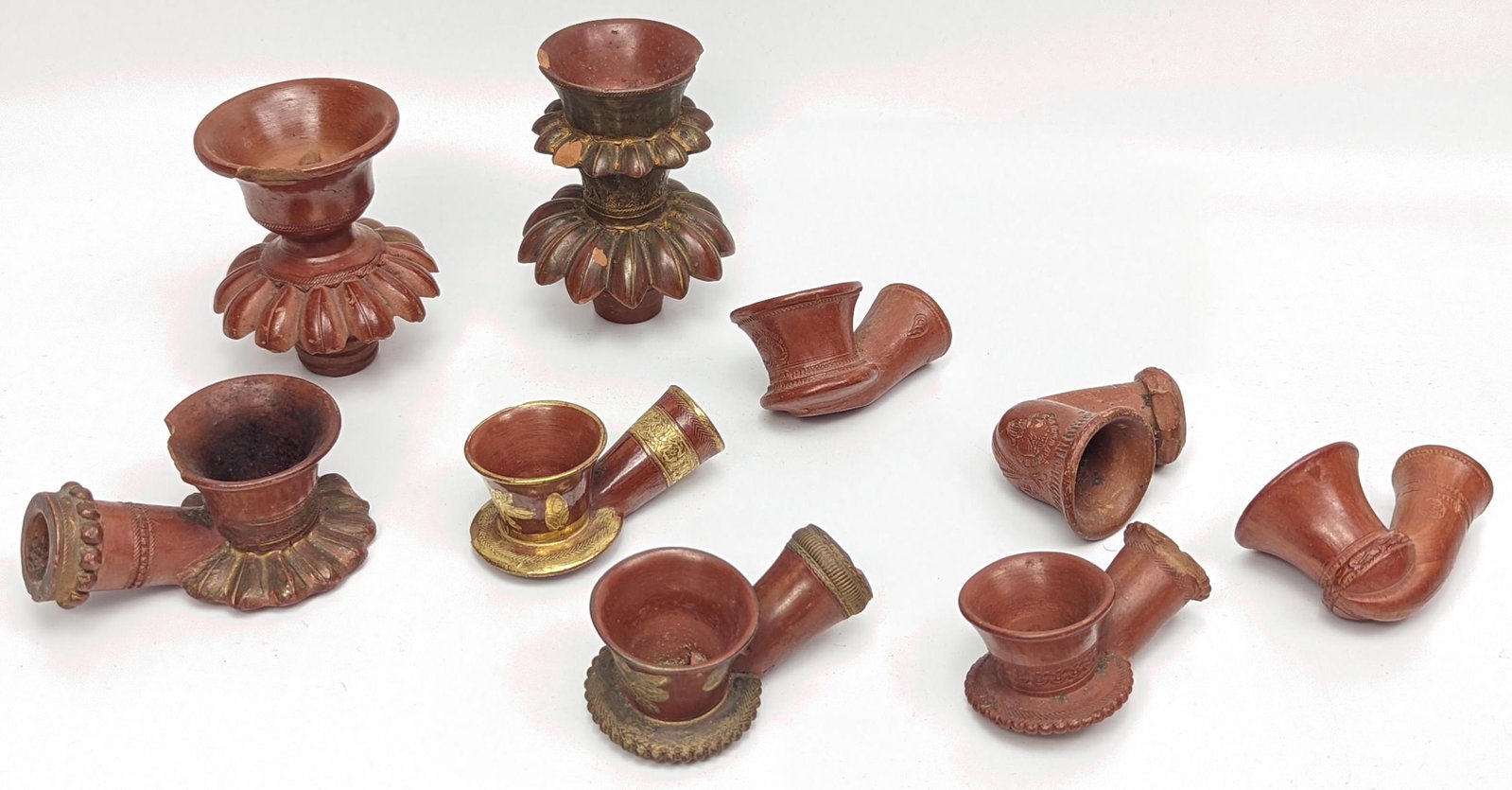 A collection of nine 19th century Ottoman Turkish Tophane clay pipes and Huqqa tops, mostly signed.: A collection of nine 19th century Ottoman Turkish Tophane clay pipes and Huqqa tops, mostly signed.