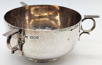 An Arts and Crafts three handled silver bowl, planished finish, hallmarked London, 1902, maker