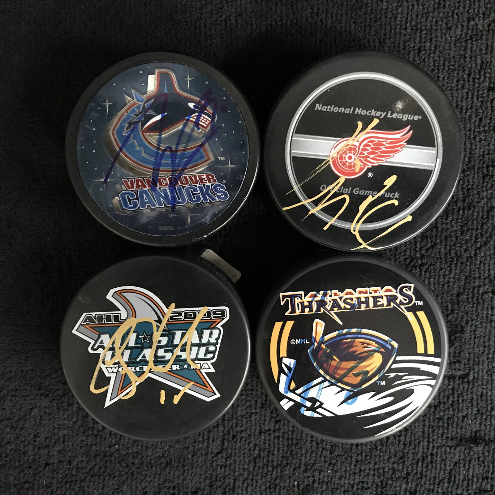 AUTOGRAPHED HOCKEY PUCK LOT (PEARSON, SCHNEIDER,: AUTOGRAPHED HOCKEY PUCK LOT (PEARSON, SCHNEIDER, KINDIL, DAFOE)