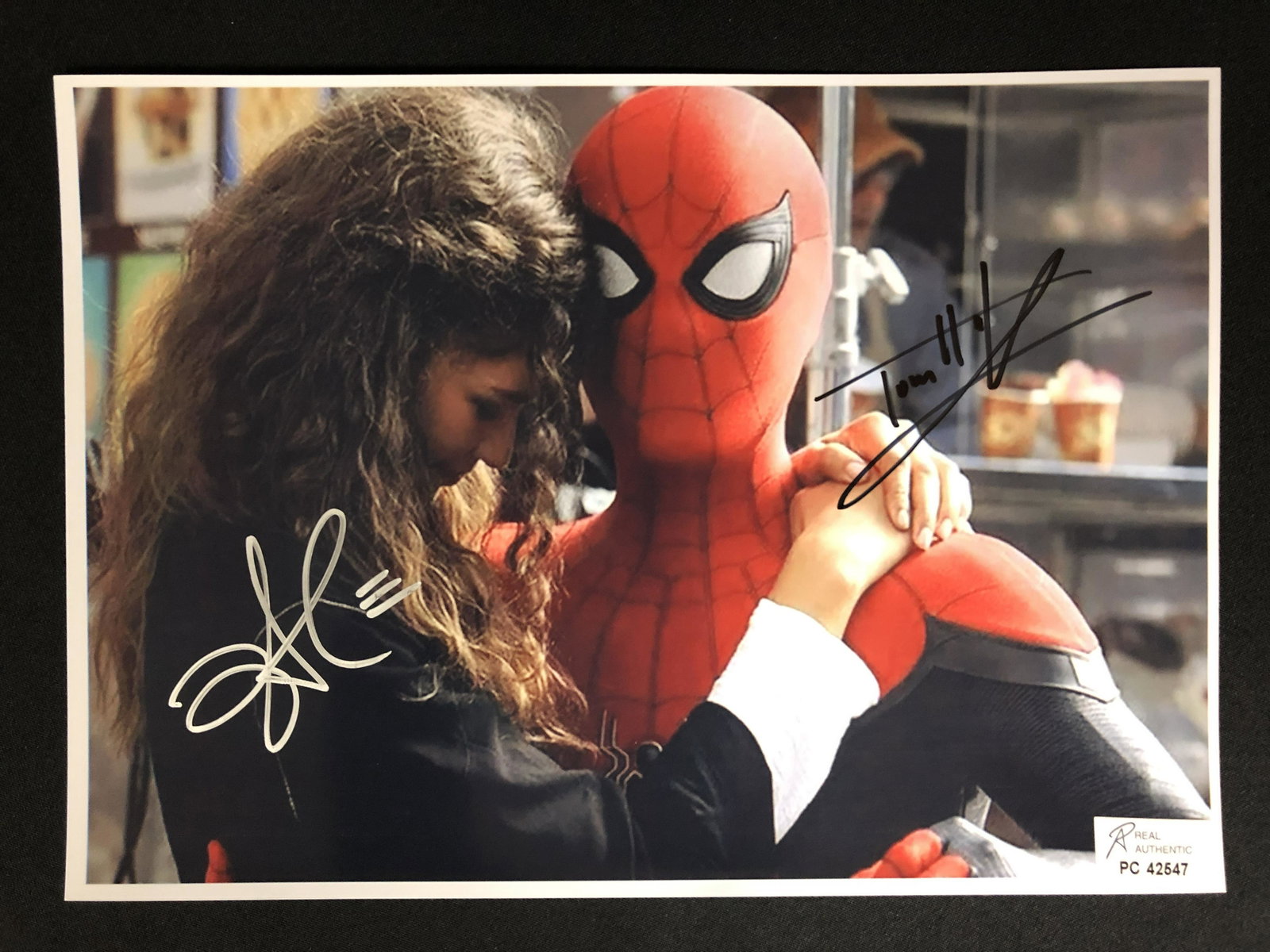 ZENDAYA AND TOM HOLLAND SIGNED SPIDER-MAN 8 X 10 (RA COA): ZENDAYA AND TOM HOLLAND SIGNED SPIDER-MAN 8 X 10 (RA COA)